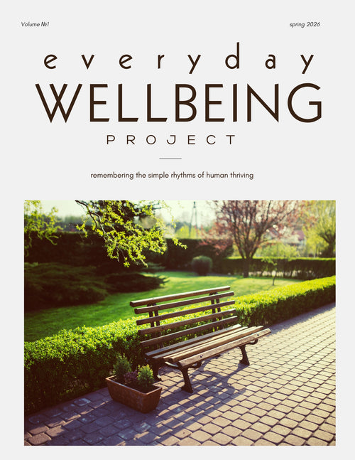 Everyday Wellbeing Project Volume 1, On Hope, spring 2026 cover: a wooden bench on a sunlit garden path beside a clipped hedge